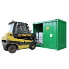 Large green outdoor drum and IBC storage unit with yellow forklift truck